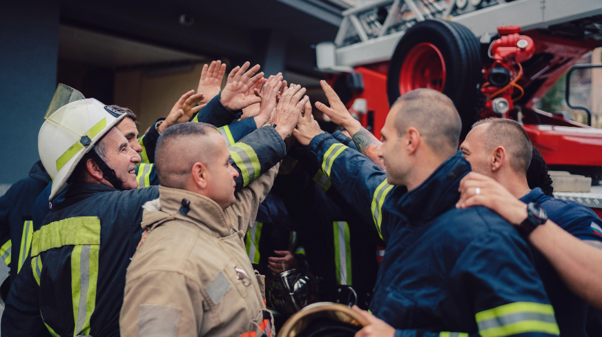 A crew of firefighters huddle together